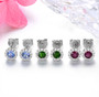 close up of tanzanite and white zircon round halo stud earrings in rhodium over sterling silver