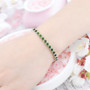 chrome diopside bracelet in rhodium over sterling silver worn on a wrist