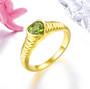 peridot 6mm heart bezel solitaire ring in 18k yellow gold over sterling silver shown in a lifestyle photo