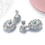 back view of sky blue topaz and white zircon dangle earrings in rhodium over sterling silver