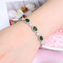 chrome diopside and white zircon bracelet in rhodium over sterling silver worn on a wrist