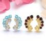 close up of blue topaz citrine and white zircon earrings in rhodium over sterling silver