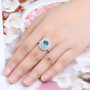 swiss blue topaz and white zircon double halo ring in 18k yellow gold over sterling silver worn on a hand
