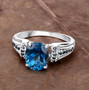 london blue topaz and blue diamond ring in rhodium over sterling silver shown in a lifestyle photo