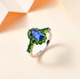 blue kyanite and chrome diopside halo ring in rhodium over sterling silver shown in a lifestyle photo