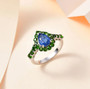 blue kyanite and chrome diopside halo ring in rhodium over sterling silver shown in a lifestyle photo