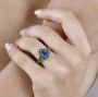 blue kyanite and chrome diopside halo ring in rhodium over sterling silver worn on a hand