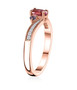 side view of rubellite tourmaline tanzanite and white zircon three stone bypass ring in 18k rose gold over sterling silver