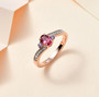 rubellite tourmaline tanzanite and white zircon three stone bypass ring in 18k rose gold over sterling silver shown in a lifestyle photo