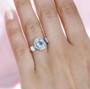 aquamarine blue and white diamond ring in 14k white gold worn on a hand