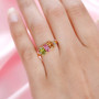 green pink and orange tourmaline trilogy ring with diamonds in 18k yellow gold over sterling silver worn on a hand