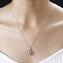 aquamarine and multi color diamond halo pendant necklace in rhodium over sterling silver worn around the neck