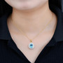 swiss blue topaz and white zircon double halo pendant necklace in 18k yellow gold over sterling silver worn around the neck