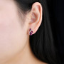 rhodolite garnet and white zircon stud earrings in rhodium over sterling silver worn on the ear