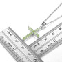 peridot cross pendant necklace in rhodium over sterling silver shown for size comparison