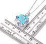 side view of sky blue topaz tanzanite and white zircon halo pendant necklace in rhodium over sterling silver