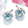 back view of sky blue topaz tanzanite and white zircon halo earrings in rhodium over sterling silver