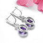 back view of amethyst and white zircon dangle earrings in rhodium over sterling silver