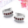 side view of garnet and white zircon hoop earrings in rhodium over sterling silver