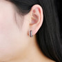 garnet and white zircon hoop earrings in rhodium over sterling silver worn on the ear