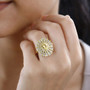 heliodor yellow sapphire and moissanite sunburst cluster ring in 18k yellow gold over sterling silver worn on a hand