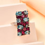 rhodolite garnet and blue zircon cluster ring in rhodium over sterling silver shown in a lifestyle photo