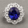 tanzanite and white diamond flower halo ring in 18k white gold shown in a lifestyle photo