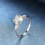 prasiolite and white zircon ring in rhodium over sterling silver shown in a lifestyle photo