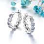 tanzanite honeycomb hoop earrings in rhodium over sterling silver shown in a lifestyle photo