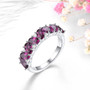 rhodolite garnet and white zircon cluster band ring in rhodium over sterling silver shown in a lifestyle photo