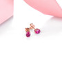 full view of untreated natural oval ruby stud earrings in 14k rose gold
