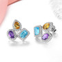 multi gemstone halo earrings in rhodium over sterling silver shown in a lifestyle photo