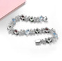 back view of blue topaz garnet chrome diopside and white zircon bracelet in rhodium over sterling silver