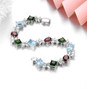 side view of blue topaz garnet chrome diopside and white zircon bracelet in rhodium over sterling silver