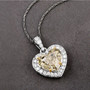 natural yellow heart and white diamond halo pendant necklace in solid 18k white gold shown in a lifestyle photo
