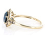 side view of london blue topaz and champagne diamond halo ring in 10k yellow gold