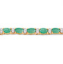 close up of blue sapphire oval and diamond tennis bracelet in solid 14k yellow gold