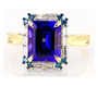 front view of tanzanite blue and white diamond halo ring in 14k yellow gold