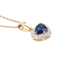 side view of sapphire and white diamond trillion halo pendant necklace in solid 14k yellow gold