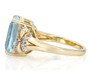 side view of emerald cut sky blue topaz and white zircon ring in 18k yellow gold over sterling silver