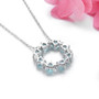 back view of sky blue topaz and zircon heart necklace in rhodium over sterling silver
