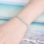 aquamarine and zircon bolo bracelet in rhodium over sterling silver worn on a wrist