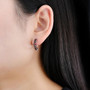 garnet hoop earrings in rhodium over sterling silver worn on the ear