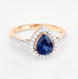 front view of pear sapphire and white diamond halo ring in 14k yellow gold