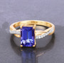 front view of emerald cut tanzanite and diamond ring in 14k yellow gold