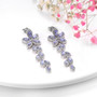 close up of tanzanite dangle earrings in rhodium over sterling silver