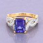 emerald cut tanzanite and diamond ring in 14k yellow gold shown in a lifestyle photo