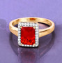 emerald cut fire opal and diamond halo ring in 14k yellow gold shown in a lifestyle photo
