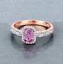 emerald cut pink sapphire and diamond halo ring in 14k rose gold shown in a lifestyle photo