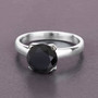 round black diamond solitaire ring in 14k white gold shown in a lifestyle photo